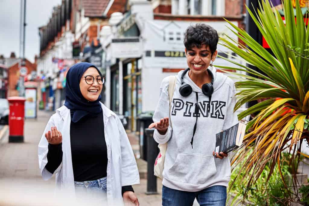 Two young women walking down the street