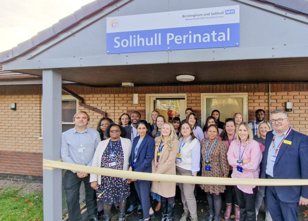 the team standing outside the new building